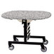 A Geneva room service table on wheels with a gray sand tri-fold top.