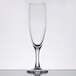 An Arcoroc champagne flute with a stem and black rim.
