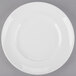 An Arcoroc white porcelain plate with a rim on a white background.