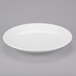 An Arcoroc white porcelain plate with a rim.