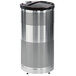 A silver Rubbermaid round steel trash can with a black lid.