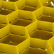 A yellow Vollrath Traex rack for 20 glasses with compartments.