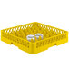 A yellow Vollrath TR11 Traex plastic dish rack with two glasses inside.