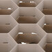 A close up of a beige plastic grid with 20 compartments on a white surface.