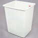 A white Rubbermaid Glutton outdoor trash container with a lid and red label.