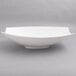 A close up of a white 10 Strawberry Street Whittier rectangular samurai bowl with curved edges.