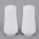 Two white 10 Strawberry Street Aurora square salt and pepper shakers on a gray surface.