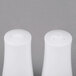 A close-up of two white Aurora Square porcelain salt and pepper shakers.