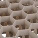 A close up of a white plastic container with a honeycomb structure.