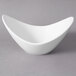 A white 10 Strawberry Street Whittier cradle bowl with a curved edge.