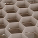 A close up of a beige hexagonal grid.