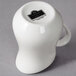 A white porcelain jug with a handle.