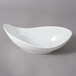 A white 10 Strawberry Street Whittier porcelain canoe bowl with a curved edge.