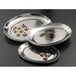 Three American Metalcraft stainless steel oval hammered trays with food on them.