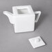 A white 10 Strawberry Street Whittier porcelain teapot with a square handle.
