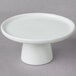 A 10 Strawberry Street Whittier white porcelain cake stand with a pedestal on a gray surface.