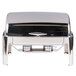 A Vollrath stainless steel roll top chafer with a lid on top.