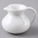 A white plastic creamer pitcher with a handle.