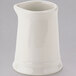 A Tuxton white ceramic pitcher with a handle.