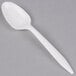 A white plastic Dart teaspoon on a gray surface.