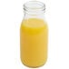 An American Metalcraft glass milk bottle filled with orange juice.