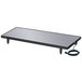 A rectangular black and silver Hatco heated shelf on a table.