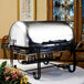 An American Metalcraft stainless steel rectangular roll top chafer on a table.