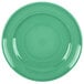 A green Tuxton Concentrix china plate with a white spiral pattern.