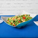 A Keywest Seabreeze Melamine bowl filled with salad on a table.