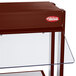 A Hatco countertop buffet warmer with a glass top over red and clear glass shelves.