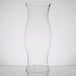 A close-up of a clear glass Libbey hurricane shade on a white background.