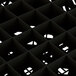 A close up of a Vollrath black glass rack grid.