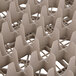 A close-up of a beige plastic grid with 49 compartments.
