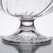 A close up of an Arcoroc clear glass dessert dish with a crystal base.