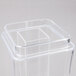 A clear plastic square beverage dispenser with a lid on top.