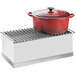 A red pot with a lid on a white rectangular Cal-Mil chafer griddle.