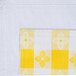 A yellow and white checkered fabric with a white flower design.