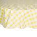 A yellow and white checkered Intedge vinyl table cover on a round table.