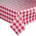 A red and white checkered Intedge vinyl table cover on an outdoor table.