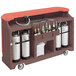 A brown Cambro portable bar with bottles and cylinders on it.