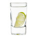 An Arcoroc tall square shot glass with a lime wedge in it.