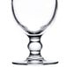 An Arcoroc hurricane glass with a small clear stem and base.