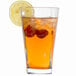 A glass of iced tea with lemon and strawberries served in an Arcoroc cooler glass.