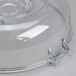 A clear glass lid with a metal handle on a Robot Coupe food processor bowl.