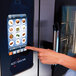 A woman using the touch screen on an Alto-Shaam Combitherm oven.
