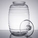 A clear glass barrel with a lid.