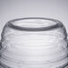 A clear glass barrel with a circular top and silver lid.