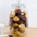 A Libbey glass jar full of cookies with a lid.