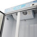 A white Turbo Air ice merchandiser with glass doors filled with bagged ice.