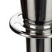 A chrome Aarco rope style crowd control stanchion with a metal top.